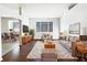 Bright living room with hardwood floors, stylish furniture, and a view into the dining area at 34434 Windknob Ct, Wesley Chapel, FL 33545