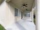 Covered patio with ceiling fans and sliding glass door access at 34434 Windknob Ct, Wesley Chapel, FL 33545