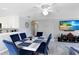 Dining area with marble table and blue velvet chairs at 15427 Winter Breeze Ln # 15427, Wimauma, FL 33598