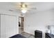 This bedroom features a ceiling fan, closet and view of hallway at 15427 Winter Breeze Ln, Wimauma, FL 33598
