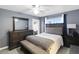 Comfortable bedroom features neutral walls, a ceiling fan, and a door to the backyard at 15427 Winter Breeze Ln, Wimauma, FL 33598