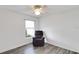 Bedroom boasting a recliner and lots of natural light from the window at 15427 Winter Breeze Ln, Wimauma, FL 33598