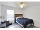 This bedroom has a ceiling fan and a window at 15427 Winter Breeze Ln, Wimauma, FL 33598