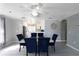Bright dining area near kitchen with white cabinets and modern lighting at 15427 Winter Breeze Ln, Wimauma, FL 33598