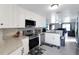 Well-lit kitchen featuring stainless steel appliances, granite counters, and white cabinets at 15427 Winter Breeze Ln, Wimauma, FL 33598