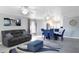 Comfortable living room featuring a sofa, dining area, and neutral decor at 15427 Winter Breeze Ln, Wimauma, FL 33598