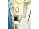 Simple bathroom with a toilet, vanity, and shower with a patterned curtain at 6302 Rosefinch Ct # 104, Lakewood Ranch, FL 34202