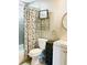 Clean bathroom with a toilet, vanity, and shower with a floral curtain at 6302 Rosefinch Ct # 104, Lakewood Ranch, FL 34202