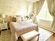 Charming bedroom featuring a queen bed, decorative mirror, and soft color scheme at 6302 Rosefinch Ct # 104, Lakewood Ranch, FL 34202