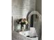 Close-up of a bedroom with a decorative mirror and a vase of flowers at 6302 Rosefinch Ct # 104, Lakewood Ranch, FL 34202