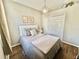 Cozy bedroom with a full-size bed, ample closet space, and light wood flooring at 6302 Rosefinch Ct # 104, Lakewood Ranch, FL 34202
