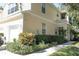 Tan two-story house with a two-car garage and well-manicured landscaping at 6302 Rosefinch Ct # 104, Lakewood Ranch, FL 34202
