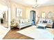 Spacious living area featuring hardwood floors and a view into the kitchen at 6302 Rosefinch Ct # 104, Lakewood Ranch, FL 34202
