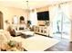 Bright living room with comfy seating, large TV, and access to a patio at 6302 Rosefinch Ct # 104, Lakewood Ranch, FL 34202