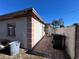 Side view of house with paved patio and trash cans at 10709 Dowry Ave, Tampa, FL 33615