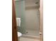 Bright bathroom with a shower featuring glass door and white tiling at 1322 Pelican Creek Xing # B, St Petersburg, FL 33707