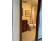 Cozy bathroom with wood cabinet, neutral tile, and bathtub with flower patterned shower curtain at 1322 Pelican Creek Xing # B, St Petersburg, FL 33707