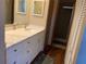 Bathroom featuring a white vanity with a solid surface countertop and modern fixtures at 1322 Pelican Creek Xing # B, St Petersburg, FL 33707
