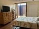 Bright bedroom with a wooden dresser, sliding glass doors to a deck, and ample closet space at 1322 Pelican Creek Xing # B, St Petersburg, FL 33707