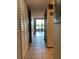 Long hallway featuring tile flooring, and access to the outside at 1322 Pelican Creek Xing # B, St Petersburg, FL 33707