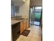 Kitchen features stone countertops, wooden cabinets, and stainless steel appliances at 1322 Pelican Creek Xing # B, St Petersburg, FL 33707