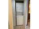 Stacked washer and dryer unit inside a laundry closet with white bi-fold doors at 1322 Pelican Creek Xing # B, St Petersburg, FL 33707