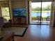 Bright living room featuring wood floors, a scenic water view, and a sliding glass door to a relaxing patio at 1322 Pelican Creek Xing # B, St Petersburg, FL 33707