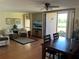 Comfortable living room featuring a ceiling fan and sliding doors opening to a waterfront patio at 1322 Pelican Creek Xing # B, St Petersburg, FL 33707