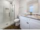 Updated bathroom with a glass shower and granite countertop vanity at 4642 Spahn St, Sarasota, FL 34232