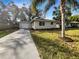 Newly renovated home with a spacious driveway and a well-manicured lawn at 4642 Spahn St, Sarasota, FL 34232