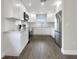 Modern kitchen with white shaker cabinets, granite countertops, and stainless steel appliances at 4642 Spahn St, Sarasota, FL 34232