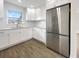 Updated kitchen boasts white cabinets, granite countertops, and stainless steel appliances at 4642 Spahn St, Sarasota, FL 34232