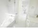 Modern, bright bathroom featuring white tile flooring, a shower, and vanity sink with modern fixtures and hardware at 37 Warrington Blvd, Port Charlotte, FL 33954