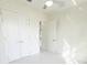 Bright bedroom featuring an open door entryway and double door closet with marble tile flooring at 37 Warrington Blvd, Port Charlotte, FL 33954
