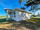 Bright exterior featuring stucco siding, well-placed windows, and blue skies overhead at 37 Warrington Blvd, Port Charlotte, FL 33954