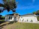 Side view of the home with well maintained lawn and attractive landscaping, showcasing its architectural design at 37 Warrington Blvd, Port Charlotte, FL 33954