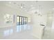 Spacious living room featuring a modern kitchen, recessed lighting, and sliding doors that open to the backyard at 37 Warrington Blvd, Port Charlotte, FL 33954