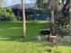 Landscaped backyard with lush grass and newly trimmed trees at 405 Sunset Dr, Venice, FL 34285