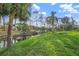 Serene backyard canal view with palm trees and lush foliage at 405 Sunset Dr, Venice, FL 34285