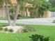 Landscaped yard with tropical plants and a view of a home at 405 Sunset Dr, Venice, FL 34285