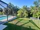 Enclosed pool and patio area with lush landscaping providing a private outdoor space at 7480 Aguila Dr, Sarasota, FL 34240