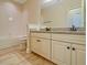 Bathroom featuring a single vanity with granite countertop, shower over tub, and tile flooring at 7480 Aguila Dr, Sarasota, FL 34240