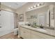 Bathroom featuring double sinks, granite countertops, and a shower-tub combination at 7480 Aguila Dr, Sarasota, FL 34240