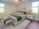 Bright bedroom with a ceiling fan, two windows, and neutral decor at 7480 Aguila Dr, Sarasota, FL 34240