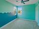 Bright bedroom with playful blue color palette, carpeting, and natural light streaming in at 7480 Aguila Dr, Sarasota, FL 34240