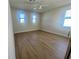 An empty bedroom with wood flooring and a ceiling fan at 7480 Aguila Dr, Sarasota, FL 34240