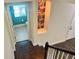 A hallway leading to a teal bathroom from a staircase at 7480 Aguila Dr, Sarasota, FL 34240