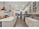 Modern kitchen boasts pendant lighting, stainless appliances, and stylish backsplash at 7480 Aguila Dr, Sarasota, FL 34240