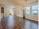 Spacious living room with tile flooring, bright windows, and stylish lighting at 7480 Aguila Dr, Sarasota, FL 34240