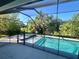 A screened-in pool and hot tub in backyard at 7480 Aguila Dr, Sarasota, FL 34240